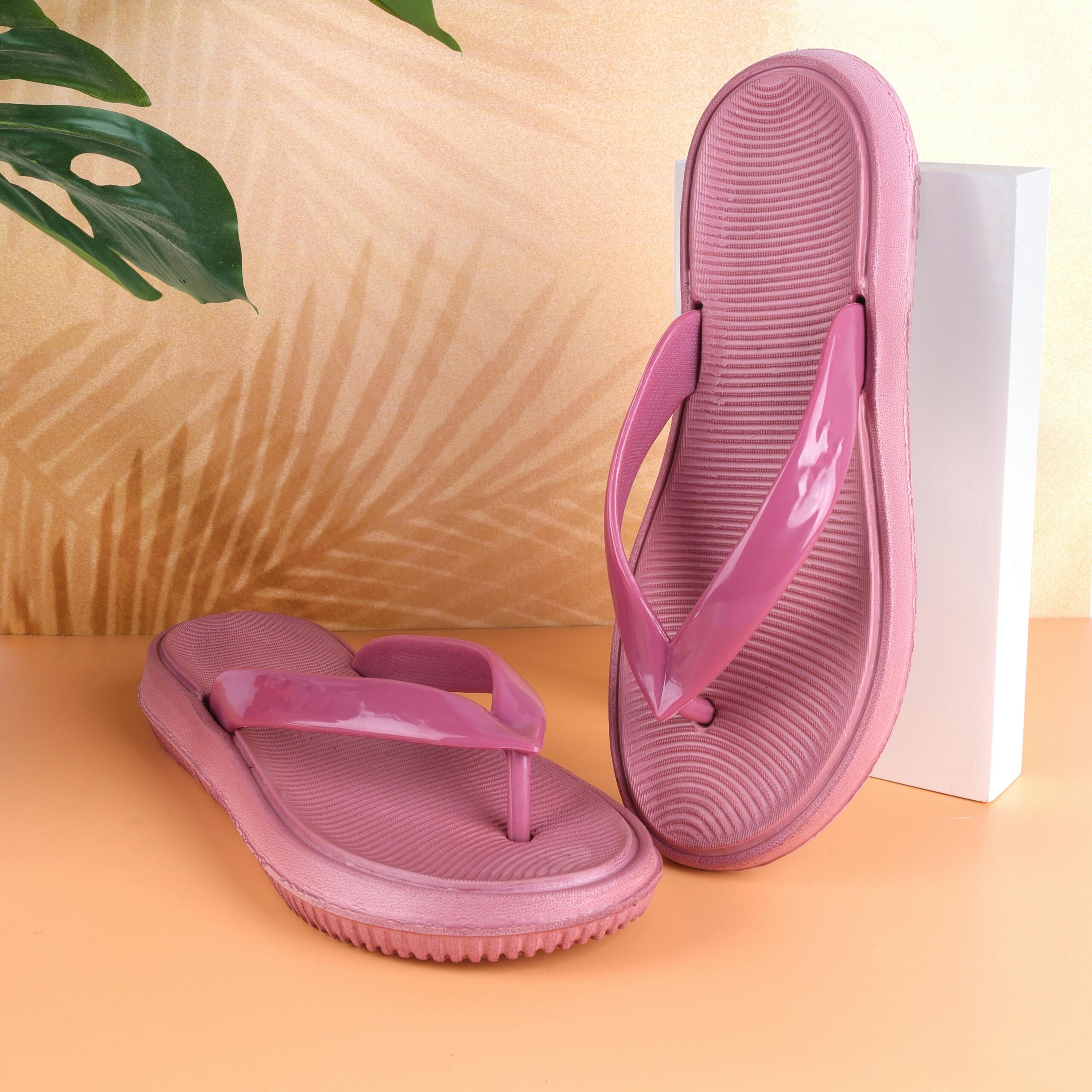 Eye-catching pink flip flops with tropical vibes, perfect for summer fashion.