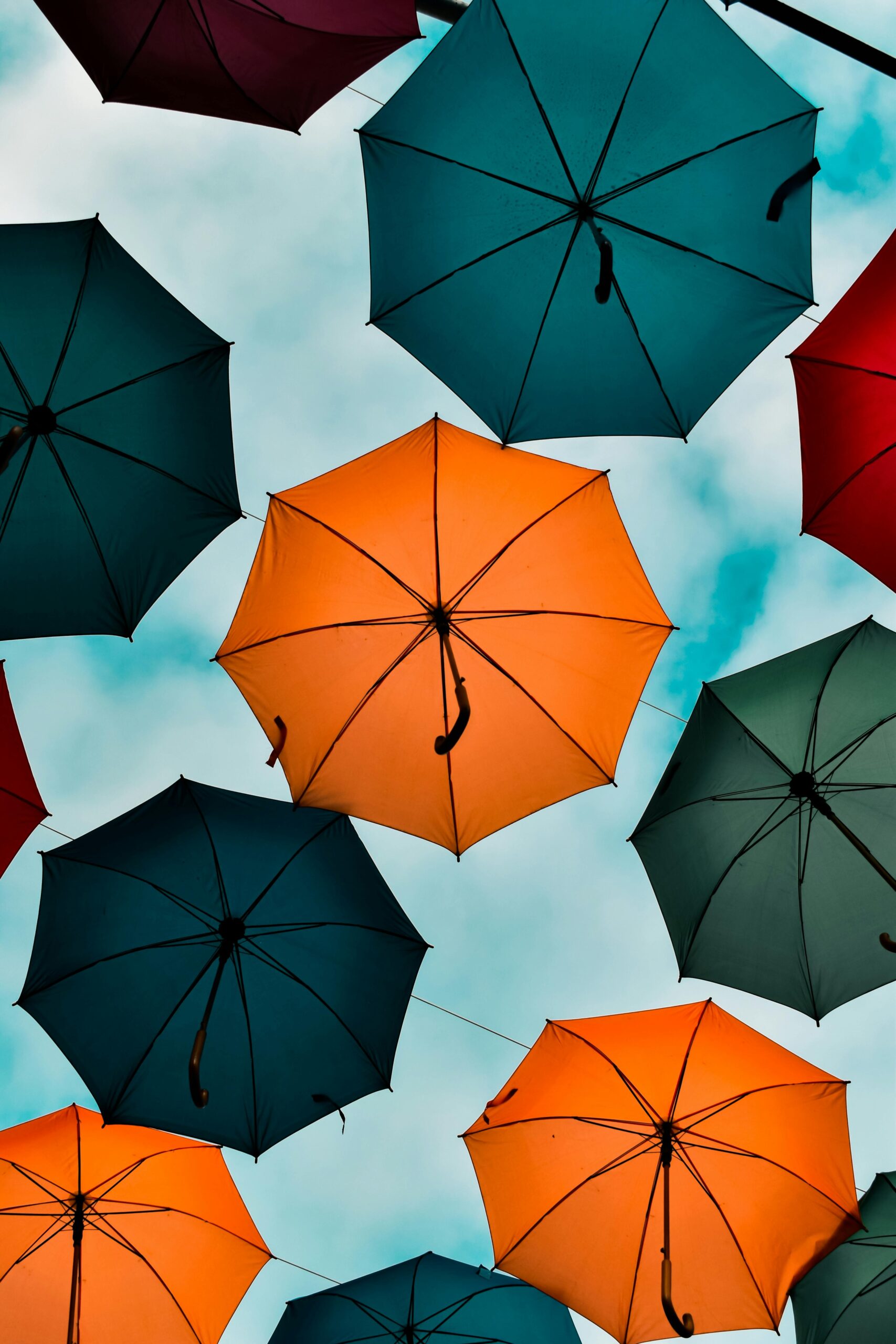 Vibrant umbrellas create an artistic and colorful display against a bright sky.