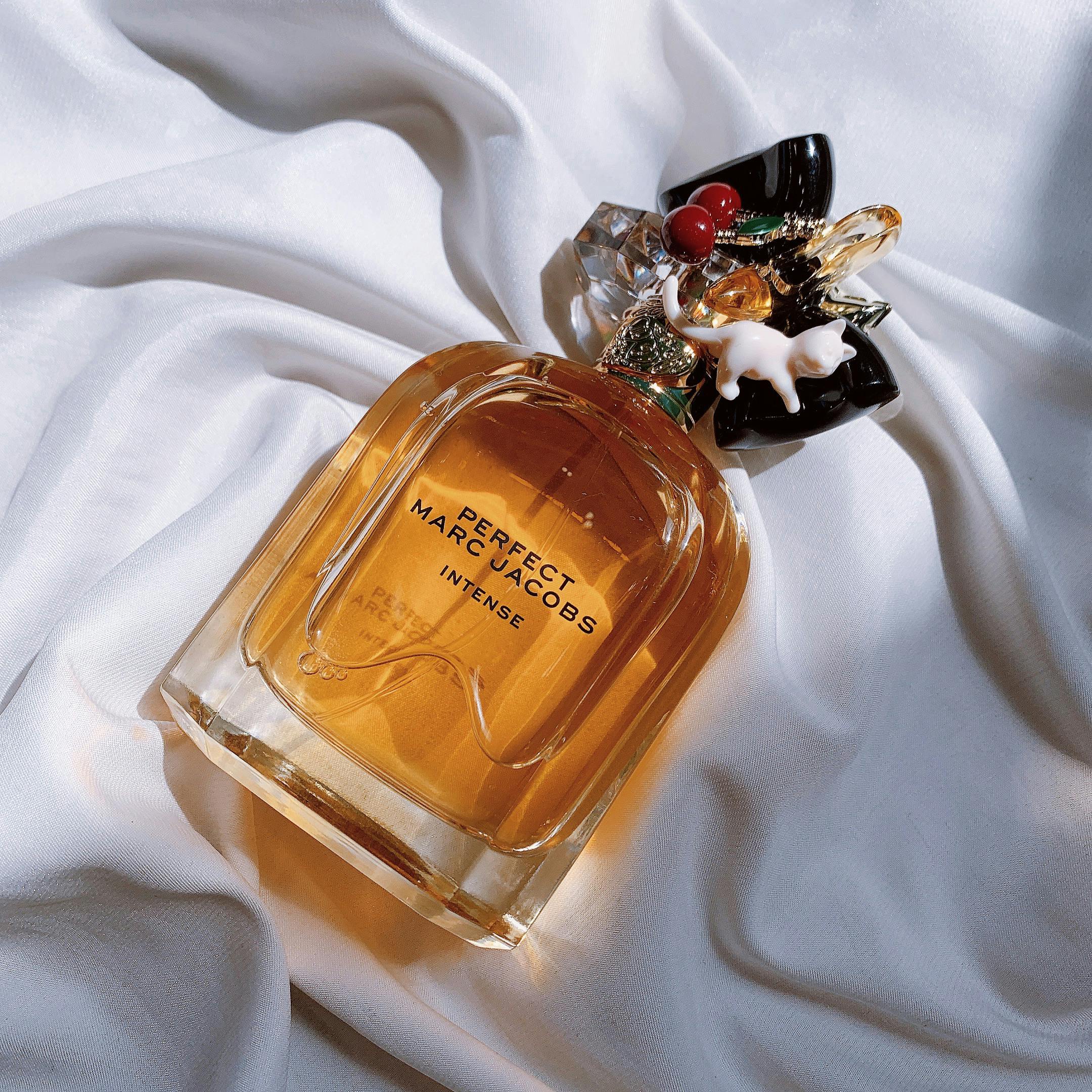 A luxurious perfume bottle rests elegantly on white satin fabric, exuding a sense of opulence and style.