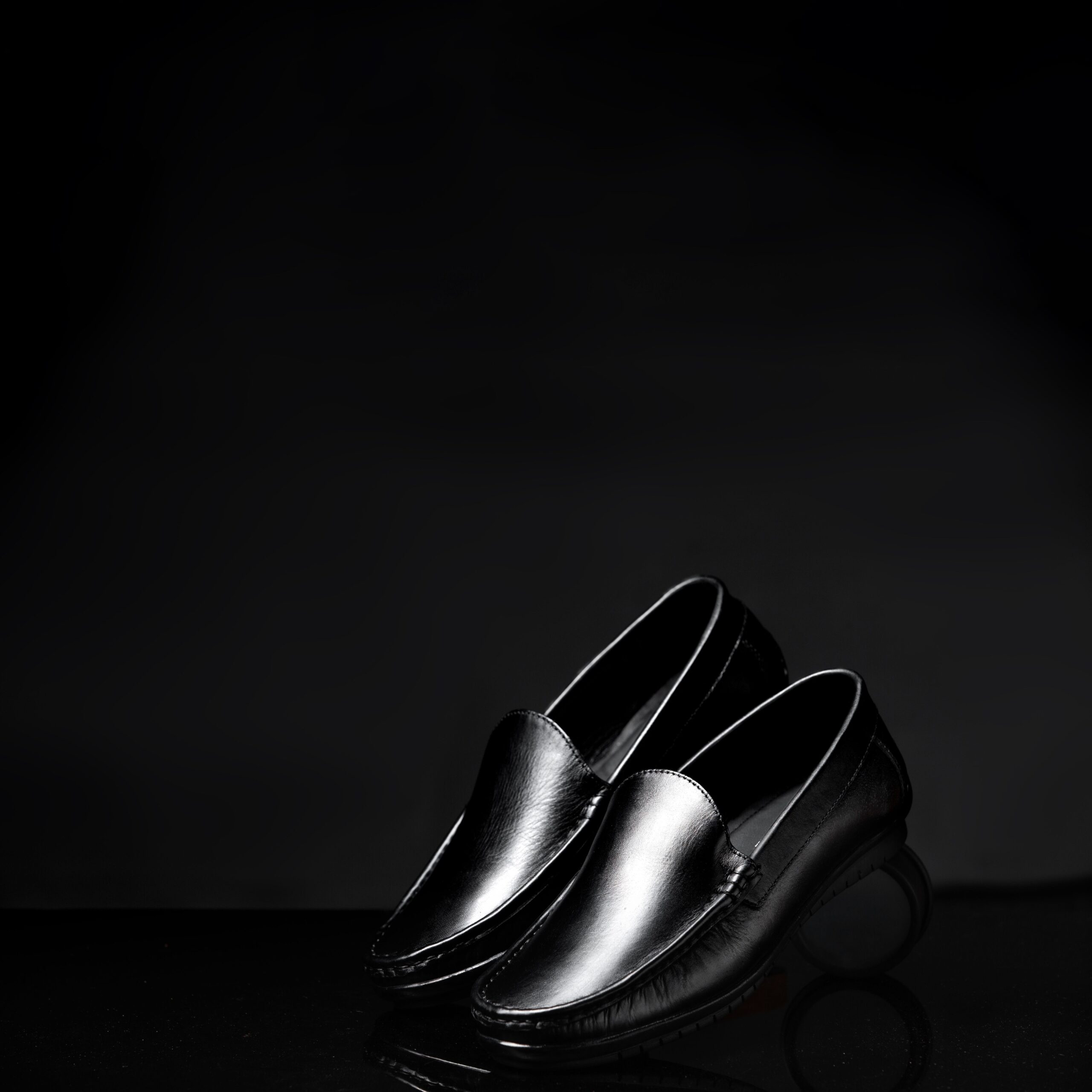 Stylish and formal black leather loafers in a sleek and classic design, ideal for fashion statements.